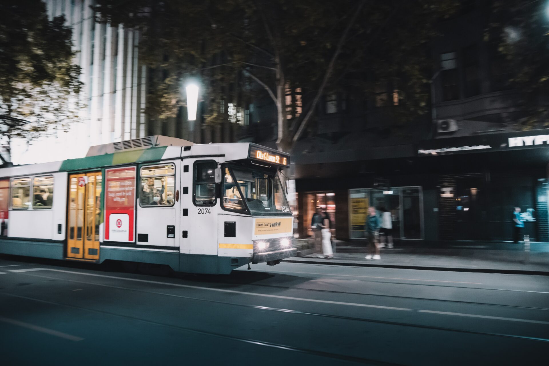 white and green tram on road during night time